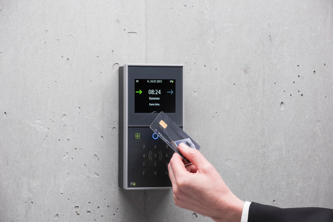 A user presenting an RFID smart card to a secure door access control reader