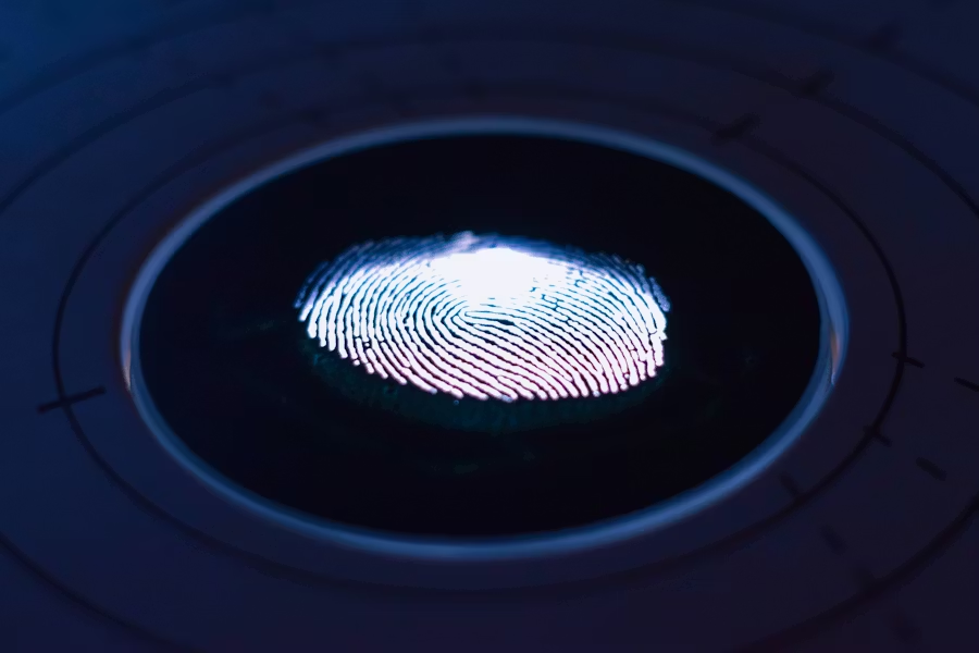 A close-up view of a fingerprint illuminated on a biometric sensor surface